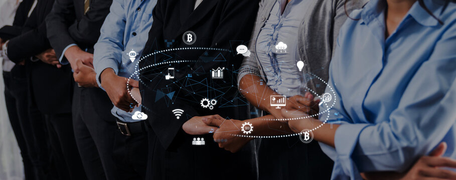 A group of diverse professionals stands in a corporate environment, symbolizing teamwork and innovation, with digital technology icons that represent connectivity and transformation. Trope
