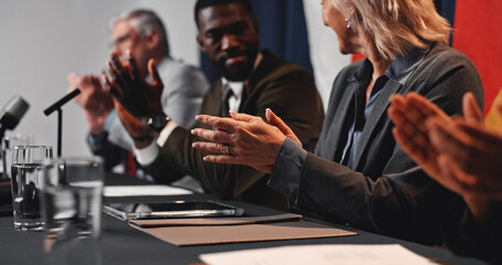 Press conference, applause and hands with group for delegation, international government and panel. Summit, people and politician at speech for diplomacy discussion, global forum or policy update
