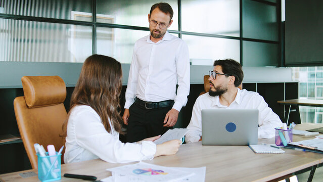 Boss fired subordinate in an office discussing project ideas during work hours in a modern corporate environment - Powered by Adobe