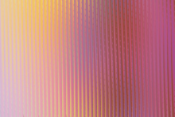 A vibrant, abstract background featuring vertical ribbed texture with a gradient of warm yellow and bright pink hues, creating a shimmering, iridescent effect