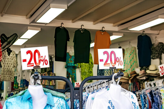 Season sale,black friday,shopping concept.stand 20 percent discount price in clothing shop.Clothes hangers in mall