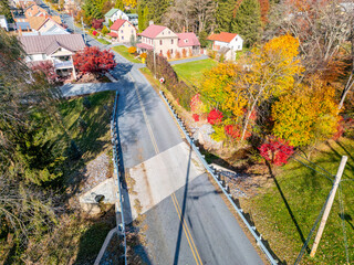 Aerial drone view of a road and bridge during fall. 
