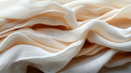 Close-up of soft, flowing fabric layers in light beige and cream tones creating gentle folds and texture