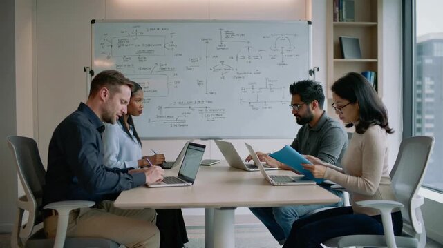 Team collaborates on project plan and innovative ideas in modern office setting with whiteboard discussion