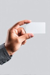 Hand Holding Blank Business Card On Gray Background