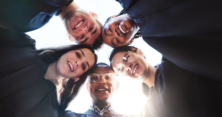 Students, graduation and portrait in low angle, happy or circle with education goals at university. People, group and smile with hug, achievement and friends for pride, excited or success at college