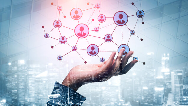 A hand extends towards an abstract digital network, symbolizing connections and communication among people amidst a futuristic city backdrop. Ideal for tech themes. Tessel