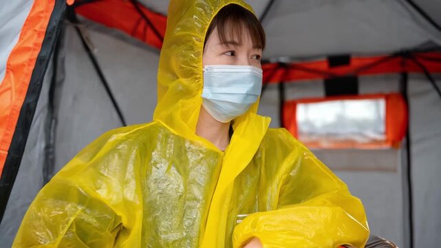 Patient wearing protective gear sitting in an isolation room focusing on quarantine measures to prevent disease spread.