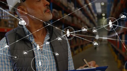 Worker starting warehouse check with clipboard pen donning helmet network overlay growing over man - Powered by Adobe