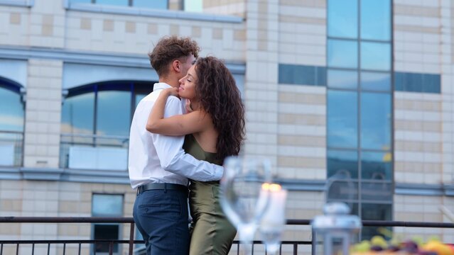 Cute young beautiful couple in elegant clothes dancing together having romantic date on rooftop. Summer date. Boyfriend and girlfriend dance outdoor. Love relations concept - Powered by Adobe