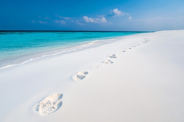 Barefoot tracks in the powdery white sands of the Maldives