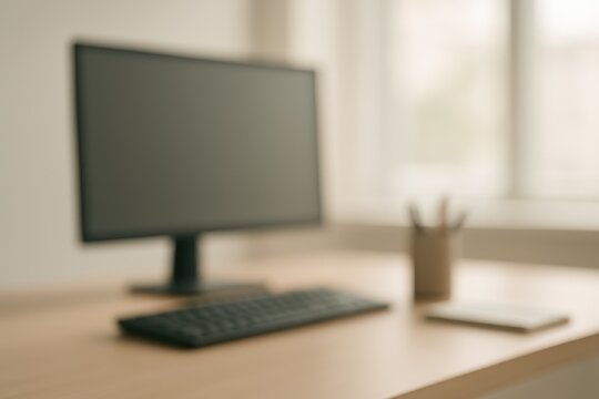 Abstract blurred office desk with computer and stationery soft corporate background bokeh