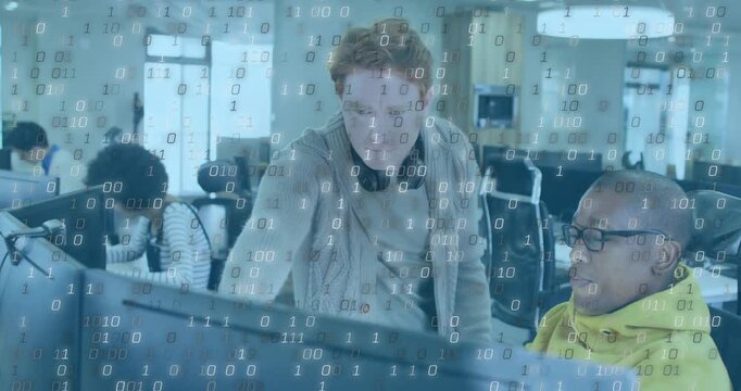 Lead dev pointing and tapping, guiding seated dev doing tech review, binary overlay over monitors