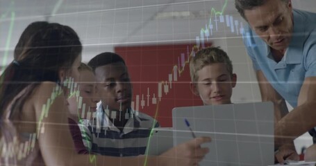 Teacher leaning over table and guiding students to laptop, finance charts expanding across screens - Powered by Adobe