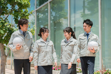 Work clothes at the construction site, construction industry in work clothes, male and female staff...