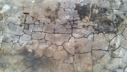 Old rustic concrete wall with peeling paint and damaged cracked grunge surface