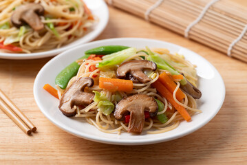 Vegetarian stir fried noodles with mushroom and vegetables with soy sauce, Asian food style