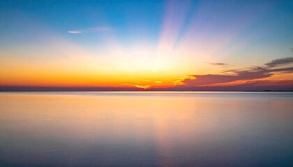 Obraz premium Tropical Beach Sunset with Palm Trees Gentle Waves and Vibrant Sky Over Calm Ocean Horizon.