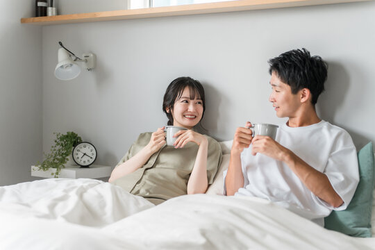 Asian couple, couple, lover, family drinking hot drinks, coffee in bedroom
