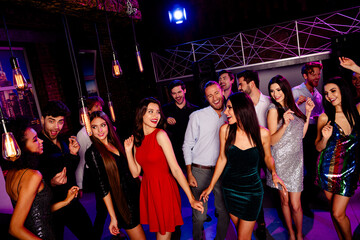 Dancefloor energy at a stylish city club party with friends dancing under neon lights and glittering outfits at a lively nightclub event