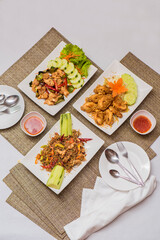 Assorted Thai Fried Dishes with Spicy Sauce and Fresh Vegetables