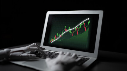 Fototapeta premium A robotic hand interacts with a laptop displaying a vibrant stock market graph, symbolizing the intersection of technology and finance in a modern business environment. Impute
