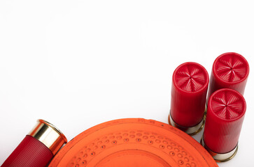 Clay shooting target with shotgun shells on white isolated background , Shotgun game © Suttiwan
