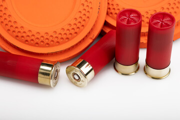 Clay shooting target with shotgun shells on white isolated background , Shotgun game © Suttiwan