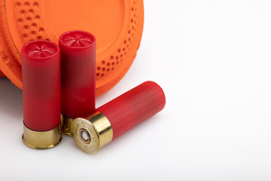 Clay shooting target with shotgun shells on white isolated background , Shotgun game