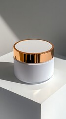 A minimalist studio product shot of a white cosmetic jar with a shiny rose gold lid presented on a clean white pedestal with soft shadows