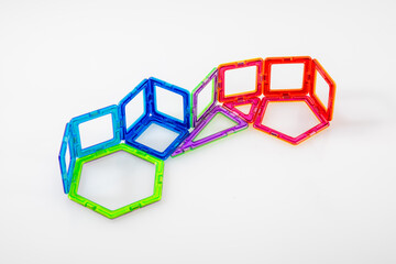 Step 1 – Colorful magnetic toy blocks connected on white background