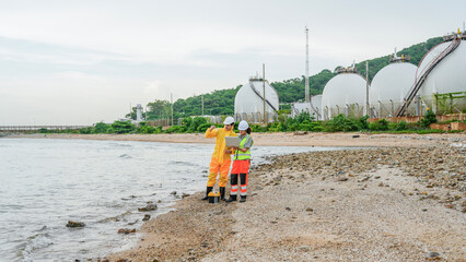 Industry professionals ensure environmental safety at a coastal energy plant. The team uses technology to monitor water quality, reflecting sustainable operations.