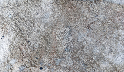 Close-up of rough cement wall with natural diagonal lines and earthy tones, offering a realistic and versatile background for creative design or texture use.