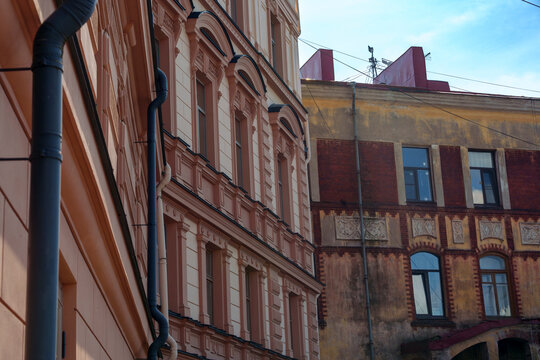 Facades of old European buildings with peeling paint and ornate details