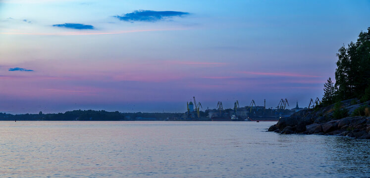 Industrial port view at sunset from rocky shore in Vyborg, Russia