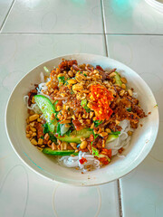 Da Lat-style grilled pork vermicelli with herbs, peanuts, cucumber, and chili paste—fresh, smoky, spicy, and full of texture