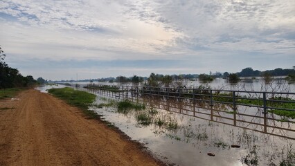 A large river overflowing its banks indicates a flood situation.