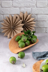 Fresh green feijoa fruit on a rustic platter
