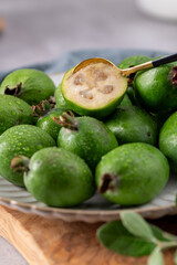 Fresh feijoa fruit with a spoon on a plate