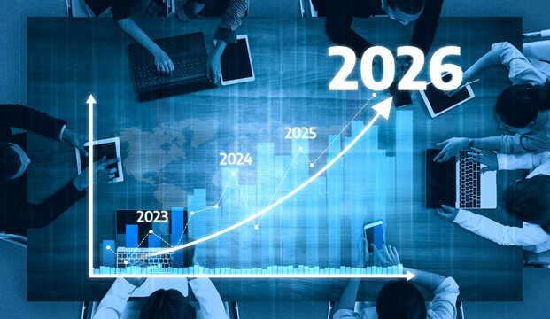Professionals gather in a modern office setting for a strategic meeting, analyzing growth projections from 2023 to 2026 using digital data visualization tools. Tessel