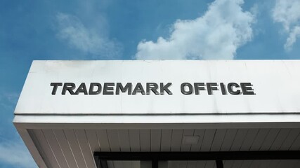 Trademark Office word sign displayed on a governmental or legal building under a clear blue sky, symbolizing intellectual property, brand registration, legal protection, business law, and commercial