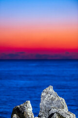 Vivid Seascape at Dawn with Color Gradient Sky and Rocks