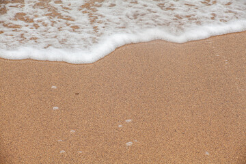 Sand and sea texture: Close-up of the coast with copy space