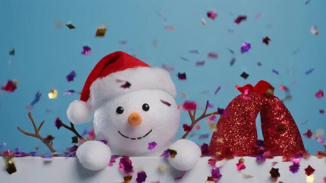 Cute snowman plush toy wearing a Santa hat with falling confetti on a blue background, celebrating winter holidays.