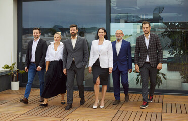 Business team walking together, diverse group of professional corporate employees and partners on...