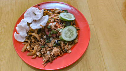 Kwetiau goreng  is a Chinese Indonesian stir fried flat rice noodle dish made from kwetiau, which are stir fried in cooking oil with garlic, onion ,beef, chicken, fried prawn, crab and other vegetable