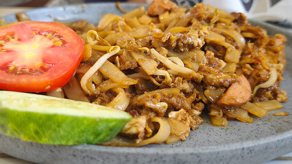 Kwetiau goreng  is a Chinese Indonesian stir fried flat rice noodle dish made from kwetiau, which are stir fried in cooking oil with garlic, onion ,beef, chicken, fried prawn, crab and other vegetable