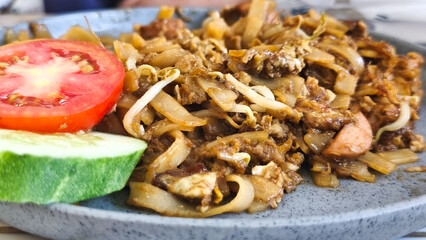 Kwetiau goreng  is a Chinese Indonesian stir fried flat rice noodle dish made from kwetiau, which are stir fried in cooking oil with garlic, onion ,beef, chicken, fried prawn, crab and other vegetable