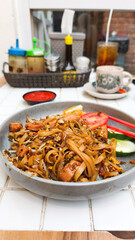 Kwetiau goreng  is a Chinese Indonesian stir fried flat rice noodle dish made from kwetiau, which are stir fried in cooking oil with garlic, onion ,beef, chicken, fried prawn, crab and other vegetable