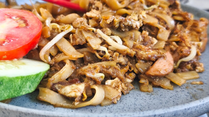 Kwetiau goreng  is a Chinese Indonesian stir fried flat rice noodle dish made from kwetiau, which are stir fried in cooking oil with garlic, onion ,beef, chicken, fried prawn, crab and other vegetable